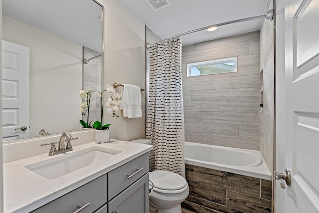 full bathroom featuring toilet, vanity, and shower / bath combination with curtain