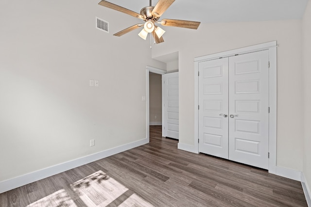 110 E Holland St, San Marcos, TX 78666 - unfurnished bedroom with wood finished floors, baseboards, a closet, and ceiling fan