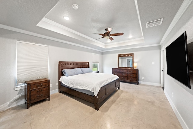 bedroom featuring crown molding, a tray ceiling, a textured ceiling, and ceiling fan