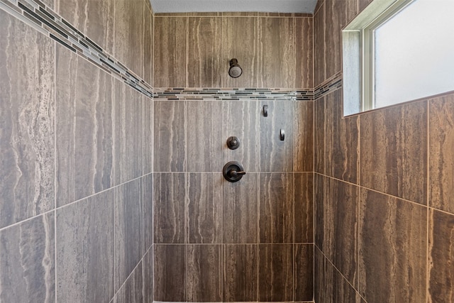 bathroom with tiled shower