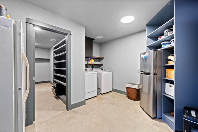 clothes washing area featuring washing machine and clothes dryer