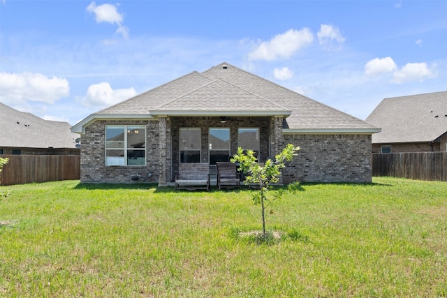 rear view of house with a lawn