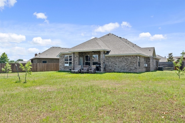 back of property with a patio and a lawn