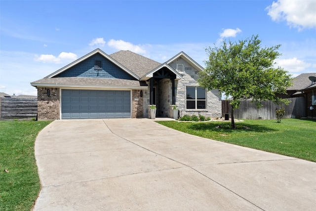 view of front of property featuring a garage and a front lawn