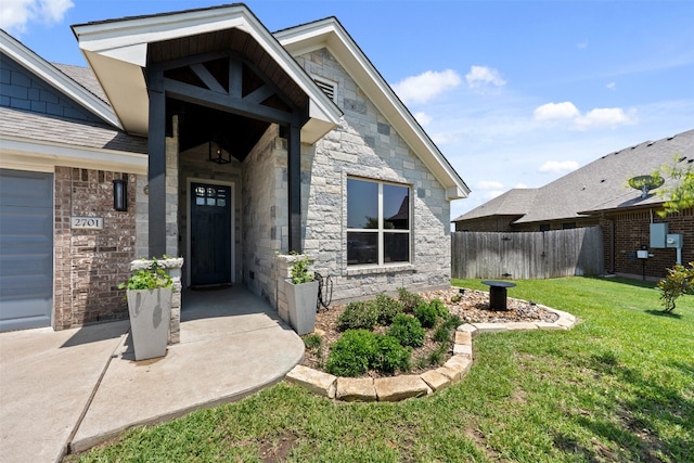 entrance to property with a lawn