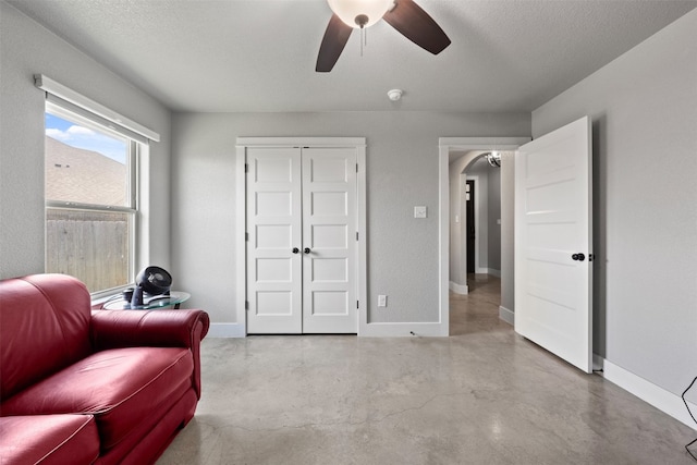 sitting room featuring ceiling fan and a textured ceiling