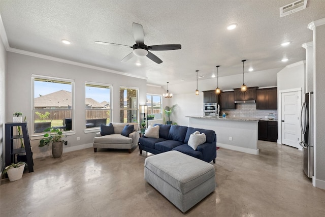 living room with ceiling fan with notable chandelier, ornamental molding, and a textured ceiling