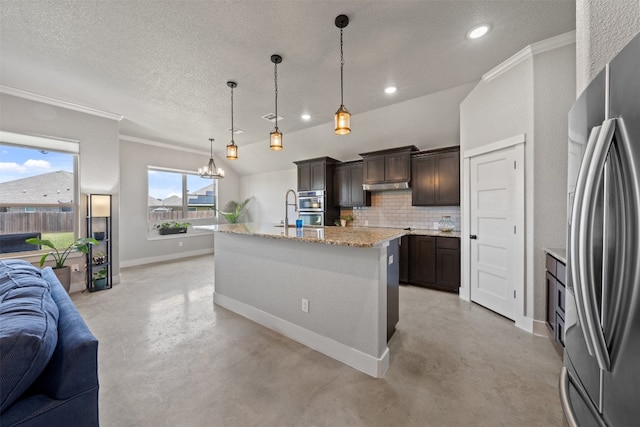 kitchen featuring dark brown cabinetry, decorative backsplash, a kitchen island with sink, hanging light fixtures, and appliances with stainless steel finishes