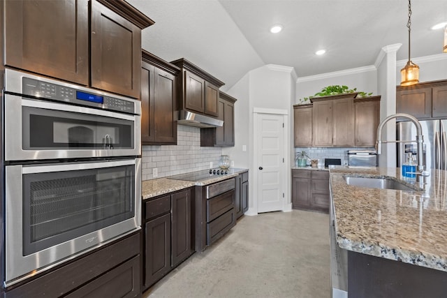 kitchen featuring dark brown cabinetry, stainless steel double oven, decorative light fixtures, sink, and backsplash