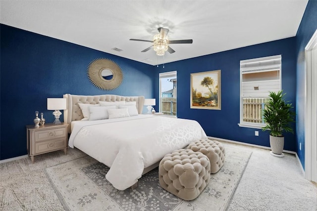 bedroom featuring visible vents, baseboards, ceiling fan, and carpet flooring