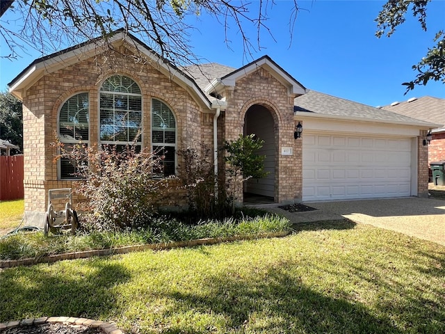 view of front of home with a front yard and a garage