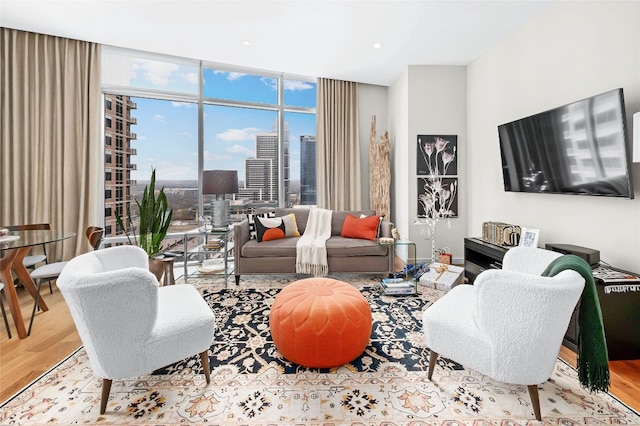 living room with expansive windows and light hardwood / wood-style flooring