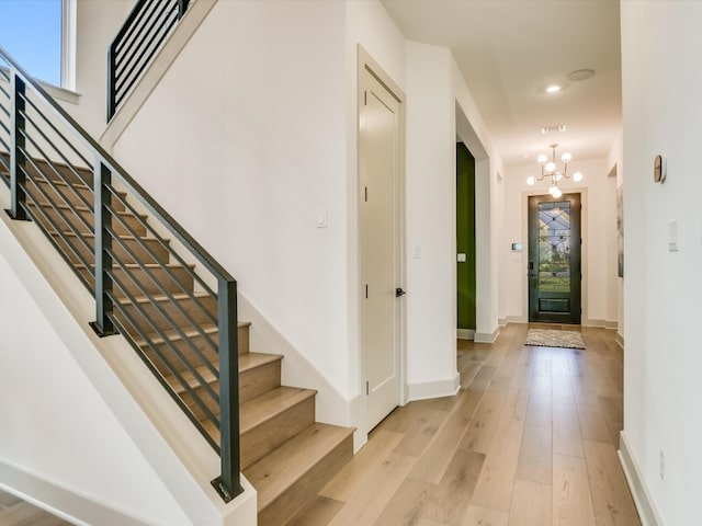 entryway with a notable chandelier and light hardwood / wood-style floors