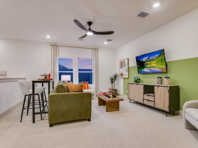 living room with light carpet and ceiling fan