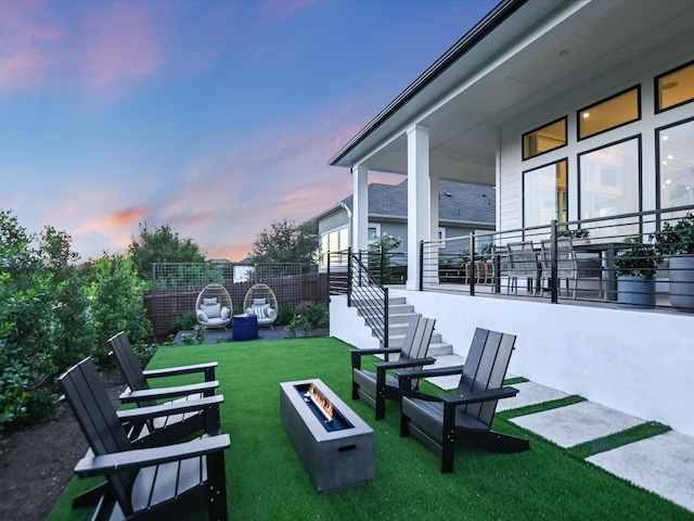 yard at dusk featuring an outdoor fire pit