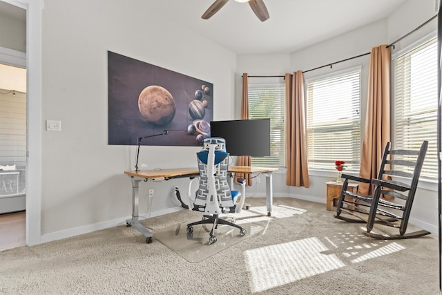 office area featuring a wealth of natural light, carpet floors, and ceiling fan