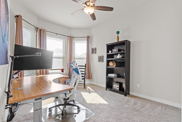 home office with light carpet and ceiling fan