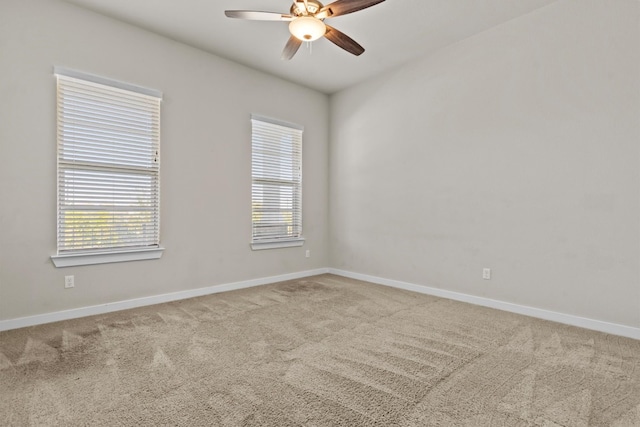 carpeted spare room with ceiling fan