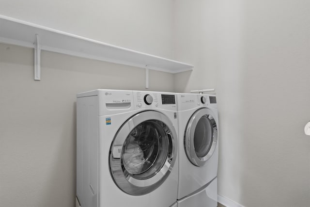 clothes washing area with independent washer and dryer