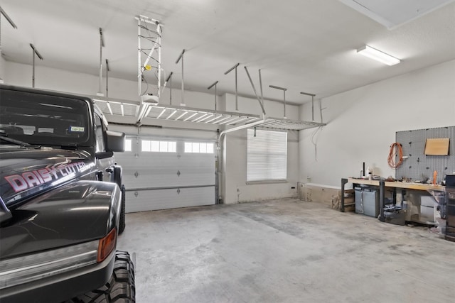 garage featuring a garage door opener and a workshop area