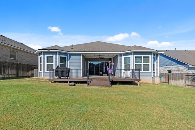 rear view of house featuring a yard, a deck, and ceiling fan