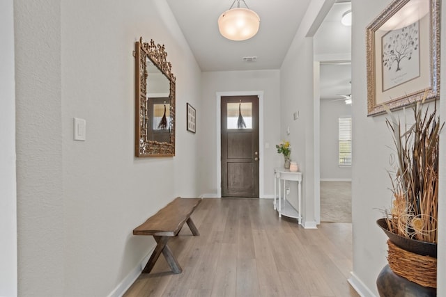 entrance foyer with ceiling fan, light wood-type flooring, and plenty of natural light