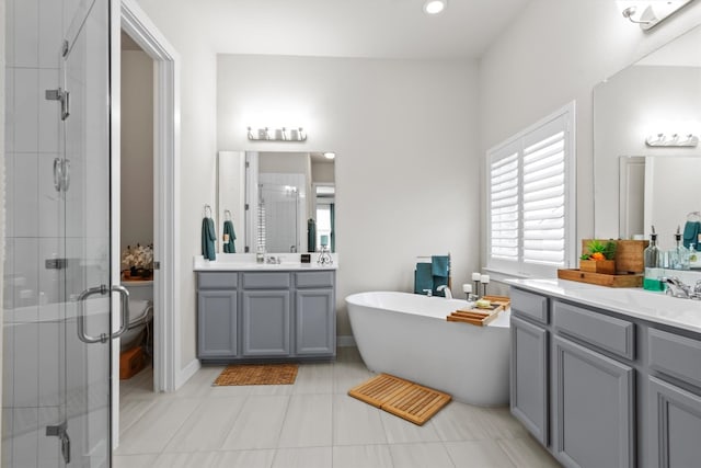 full bathroom featuring vanity, separate shower and tub, toilet, and tile patterned floors