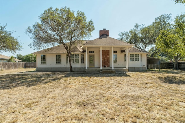 view of front of property with a front yard, a porch, and a carport