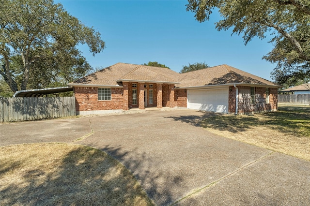 view of front of property with a carport and a garage