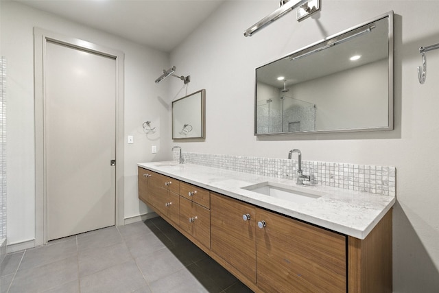 bathroom featuring vanity, tasteful backsplash, tile patterned floors, and a shower with door