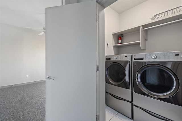 washroom featuring ceiling fan, washer and dryer, and light tile patterned floors