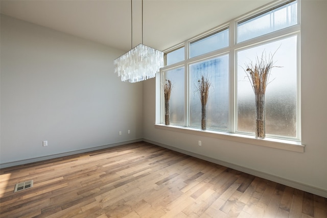 unfurnished dining area with a healthy amount of sunlight and light hardwood / wood-style flooring