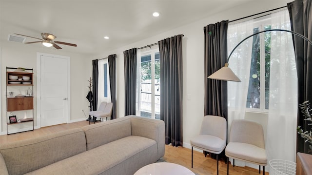 living room with recessed lighting, wood finished floors, a ceiling fan, and baseboards