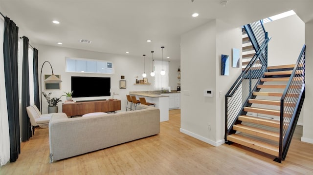 510 Blackson Ave Unit 2, Austin, TX 78752 - living area featuring light wood finished floors, stairway, recessed lighting, and baseboards