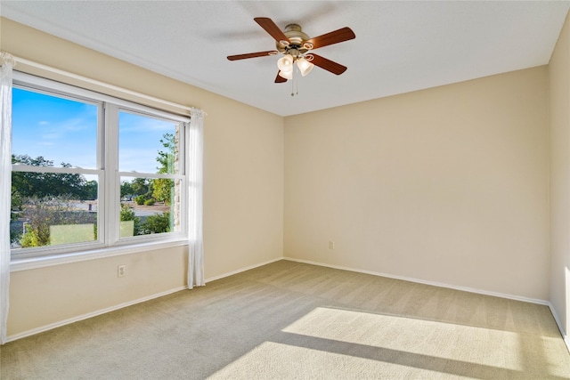 carpeted spare room with ceiling fan