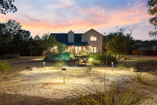 view of back house at dusk