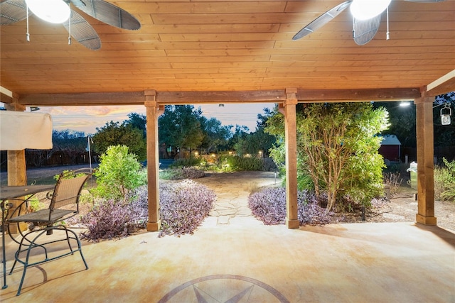 patio terrace at dusk featuring ceiling fan