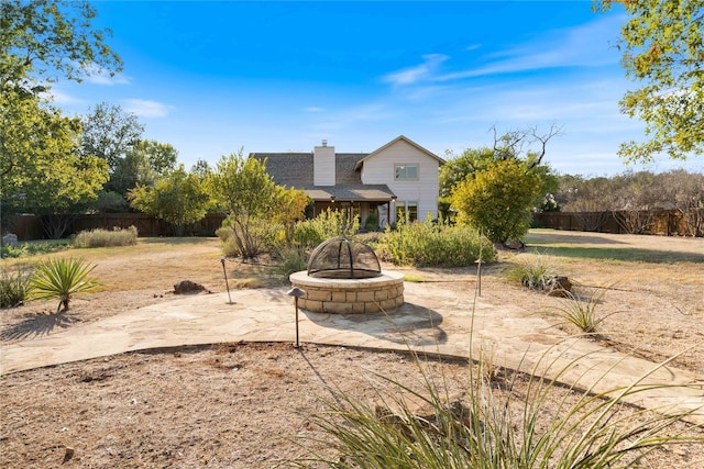 exterior space with a patio area and an outdoor fire pit