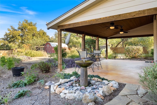 view of patio featuring ceiling fan and a storage shed