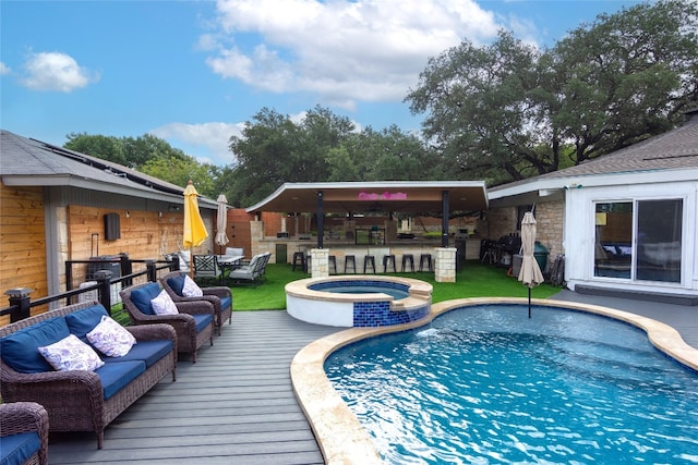 view of swimming pool featuring outdoor lounge area, an in ground hot tub, and a deck