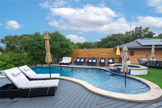 view of swimming pool featuring a wooden deck, an in ground hot tub, and pool water feature