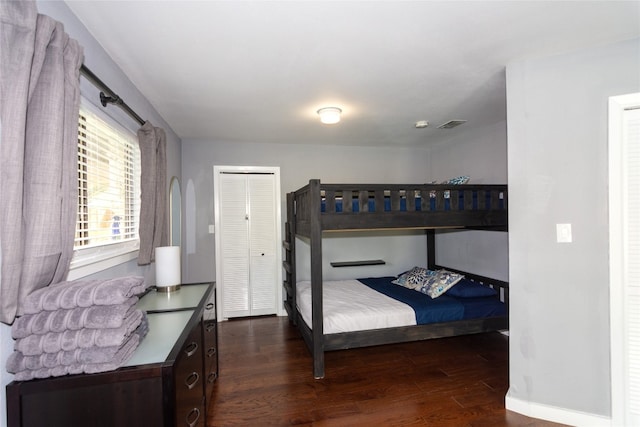 bedroom with a closet and dark hardwood / wood-style floors