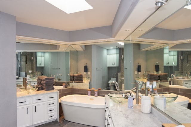 bathroom featuring tile patterned flooring, decorative backsplash, vanity, and shower with separate bathtub