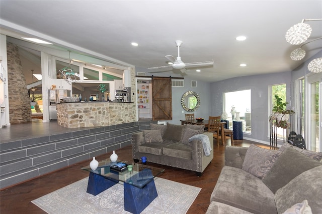 living room featuring a barn door, dark wood-type flooring, lofted ceiling, and ceiling fan