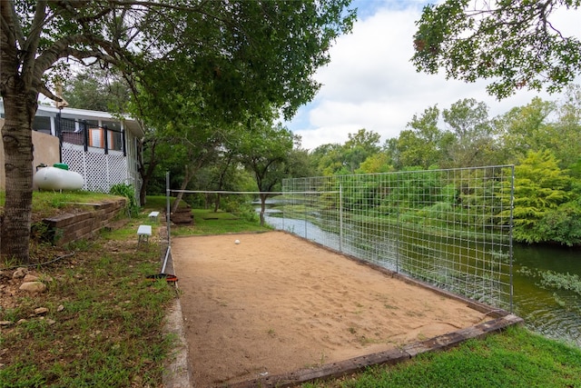 view of community with a water view and volleyball court