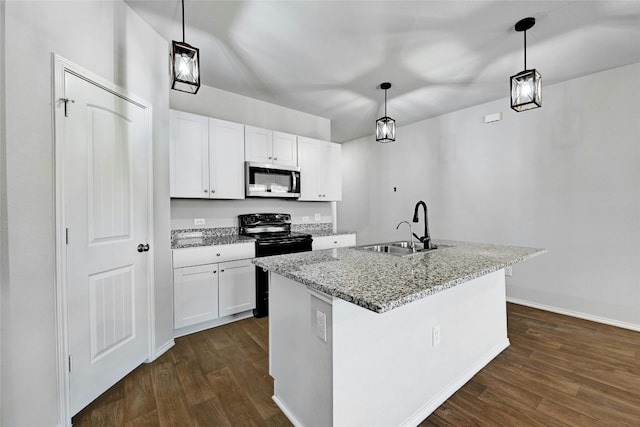 kitchen with light stone counters, pendant lighting, a center island with sink, and white cabinetry