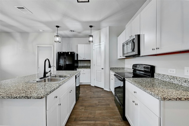 kitchen featuring dark hardwood / wood-style flooring, sink, an island with sink, white cabinets, and black appliances