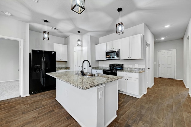 kitchen featuring an island with sink, black appliances, sink, and white cabinets