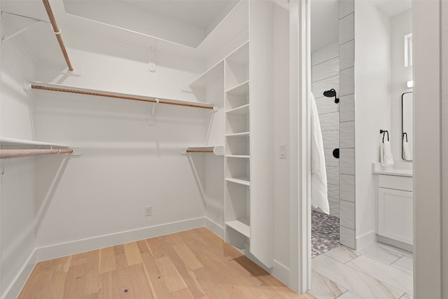 walk in closet featuring light hardwood / wood-style floors