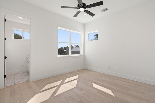 spare room featuring ceiling fan and light hardwood / wood-style floors